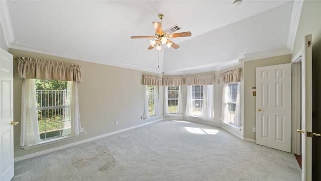 carpeted empty room with ceiling fan, crown molding, and vaulted ceiling