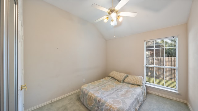 bedroom with ceiling fan, light carpet, vaulted ceiling, and multiple windows