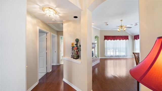 hall with crown molding and dark wood-type flooring