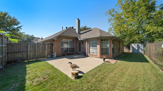 back of house featuring a yard and a patio