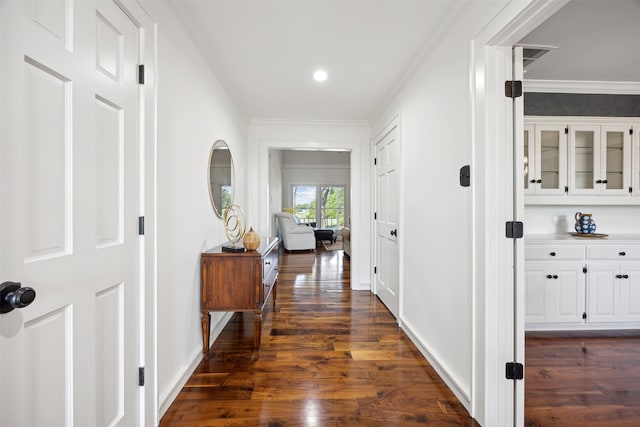 hallway featuring crown molding and dark hardwood / wood-style flooring