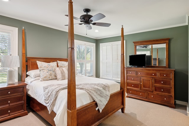 carpeted bedroom featuring crown molding and ceiling fan