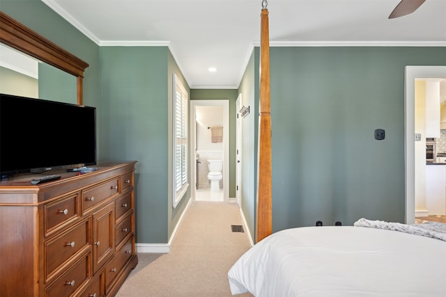 bedroom featuring crown molding, connected bathroom, and light colored carpet