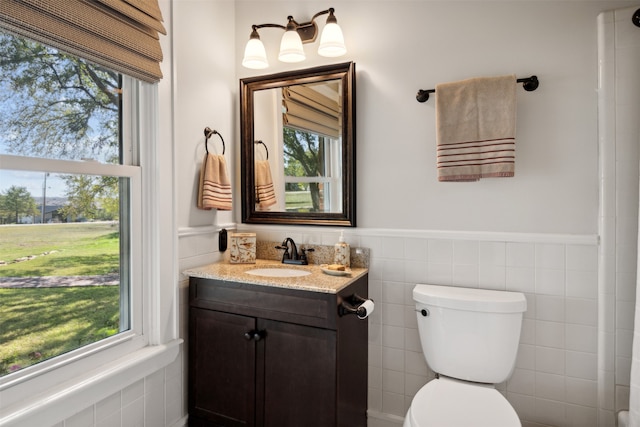 bathroom featuring plenty of natural light, vanity, and toilet