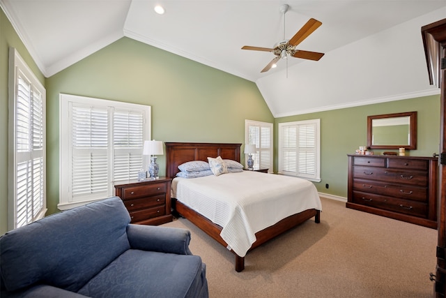 carpeted bedroom with ornamental molding, vaulted ceiling, and ceiling fan