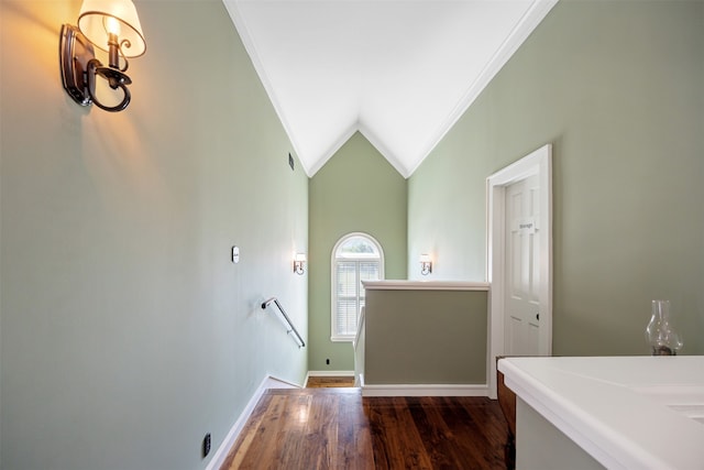 entryway featuring ornamental molding, vaulted ceiling, and dark hardwood / wood-style flooring