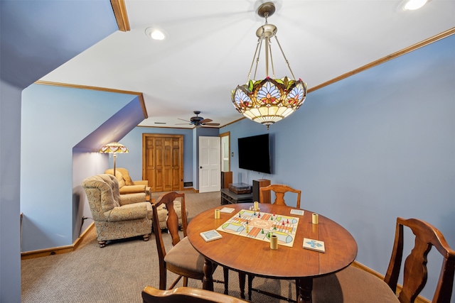 dining space with ceiling fan, crown molding, carpet flooring, and vaulted ceiling