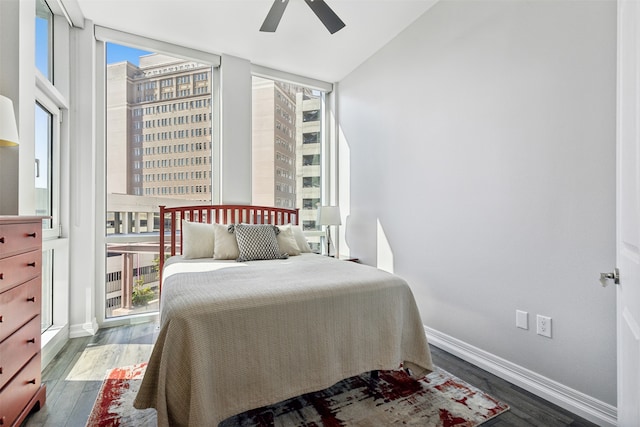 bedroom featuring ceiling fan, floor to ceiling windows, and dark hardwood / wood-style flooring