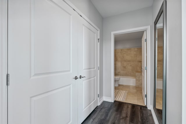 hall with dark hardwood / wood-style floors