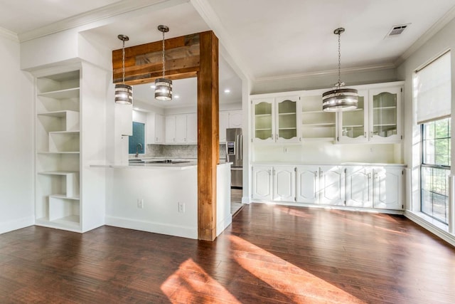 kitchen featuring stainless steel fridge, dark hardwood / wood-style floors, and white cabinetry