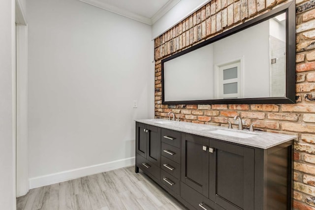 bathroom featuring wood-type flooring, vanity, and ornamental molding