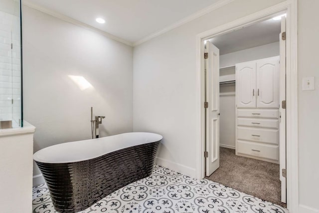 bathroom featuring a tub to relax in and crown molding