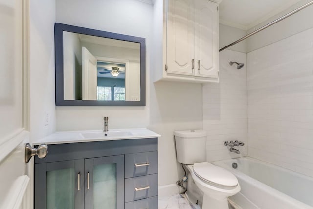 full bathroom with ceiling fan, toilet, crown molding, tiled shower / bath, and vanity