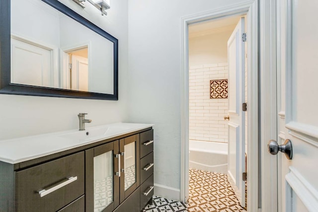 bathroom featuring tile patterned floors, vanity, and tiled shower / bath