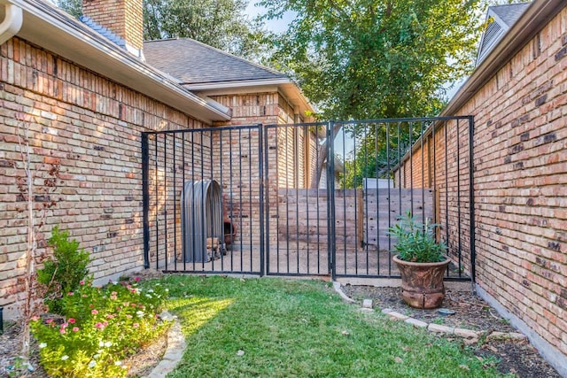 view of gate featuring a yard