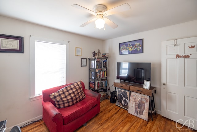 living room featuring ceiling fan, hardwood / wood-style flooring, and plenty of natural light