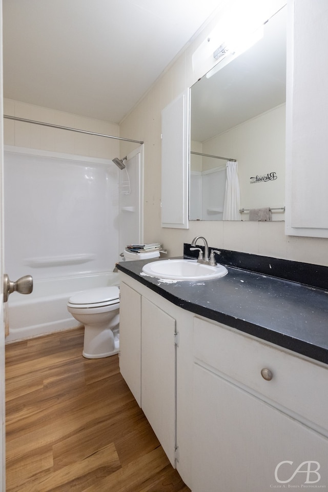 full bathroom with toilet, shower / tub combo, vanity, and wood-type flooring