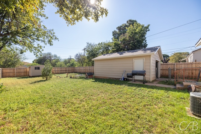 view of yard featuring a storage shed and cooling unit