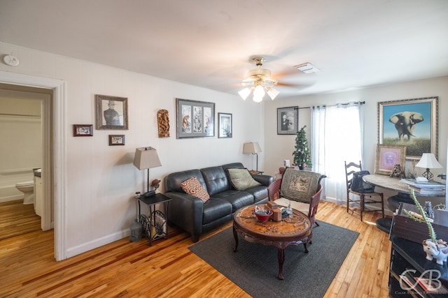 living room featuring hardwood / wood-style flooring and ceiling fan