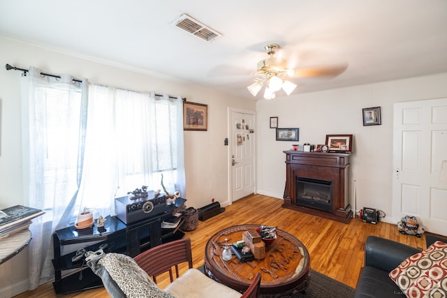 living room featuring light hardwood / wood-style flooring and ceiling fan