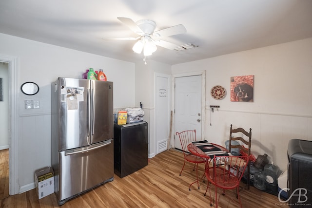 kitchen featuring wood-type flooring, stainless steel refrigerator, and ceiling fan