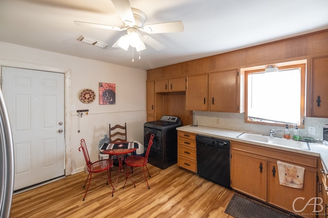 kitchen featuring washer / clothes dryer, dishwasher, light wood-type flooring, and tasteful backsplash