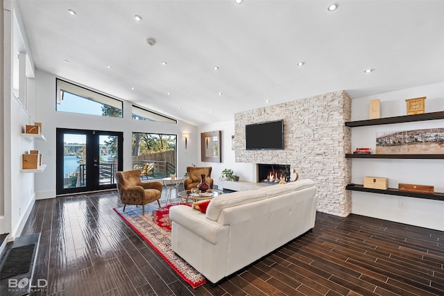 living room featuring a stone fireplace, french doors, dark hardwood / wood-style floors, and high vaulted ceiling