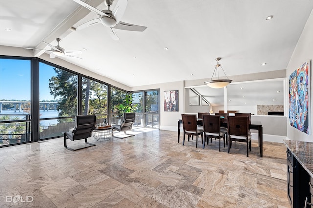 interior space with a water view and ceiling fan