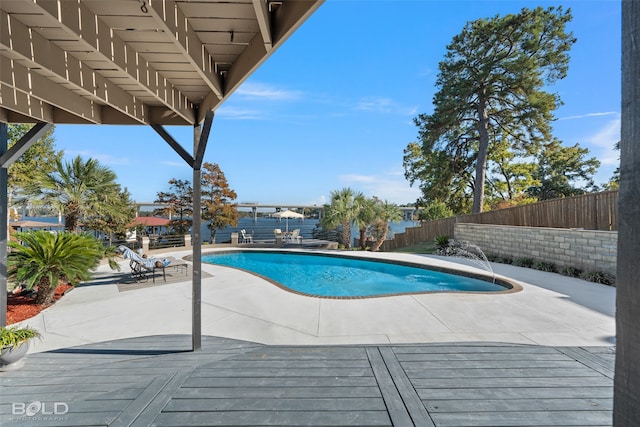 view of swimming pool featuring a water view, pool water feature, and a patio area