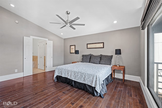 bedroom with dark wood-type flooring, ceiling fan, vaulted ceiling, and ensuite bath