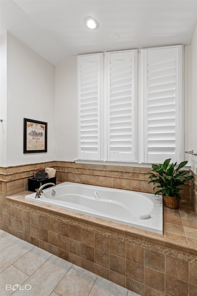 bathroom featuring tile patterned floors and tiled bath