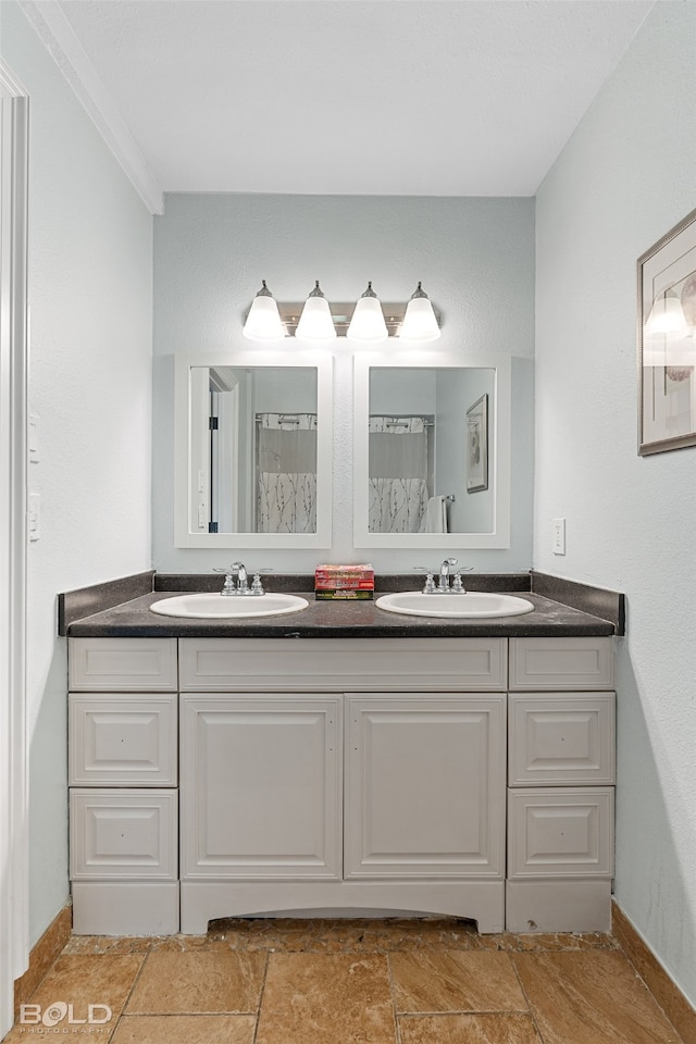 bathroom featuring vanity and ornamental molding