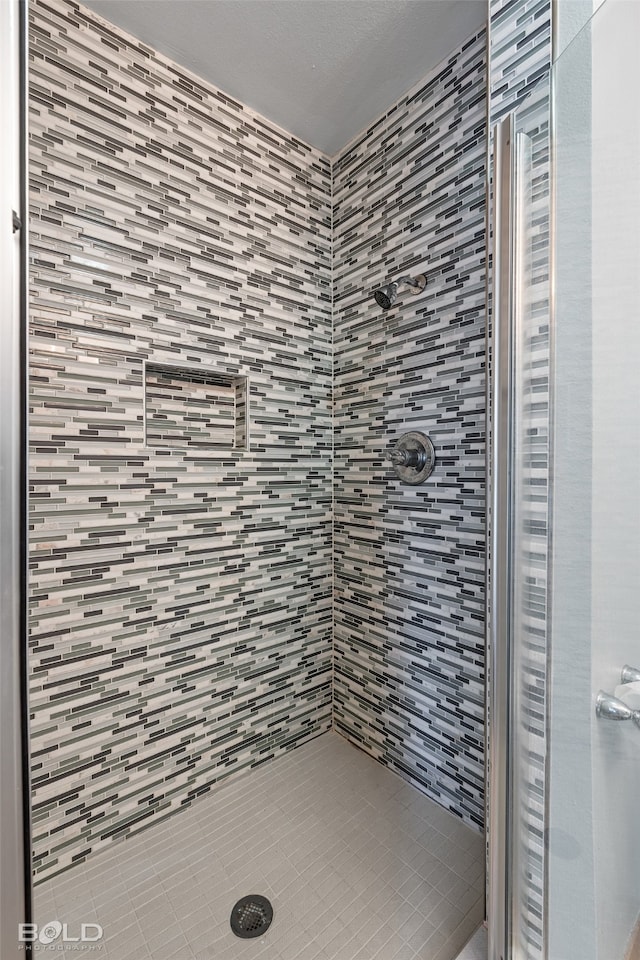 bathroom with tiled shower