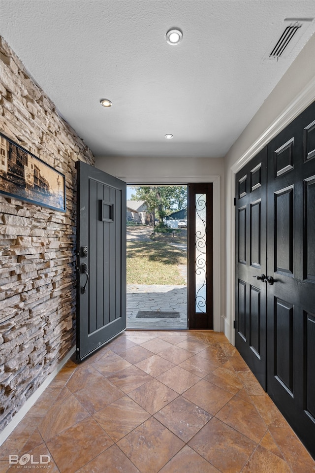 entrance foyer featuring a textured ceiling