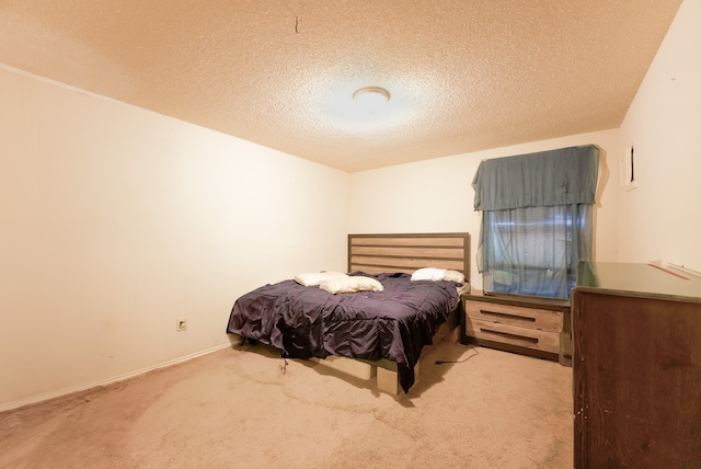 carpeted bedroom with a textured ceiling