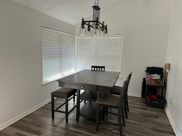 dining space featuring a textured ceiling, a notable chandelier, vaulted ceiling, and dark hardwood / wood-style flooring