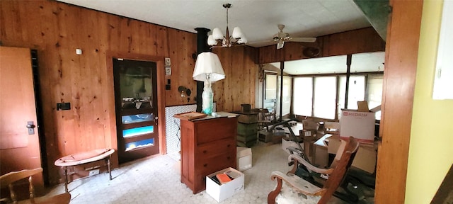 misc room with wooden walls and ceiling fan