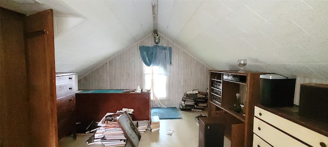 bonus room featuring lofted ceiling, concrete flooring, and ceiling fan