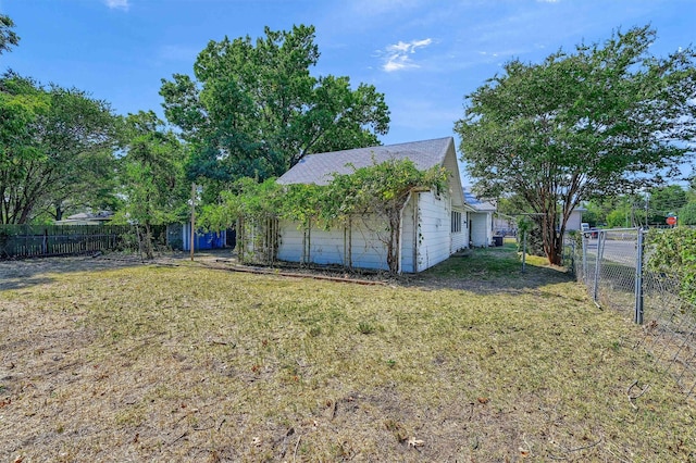 view of side of property with a yard