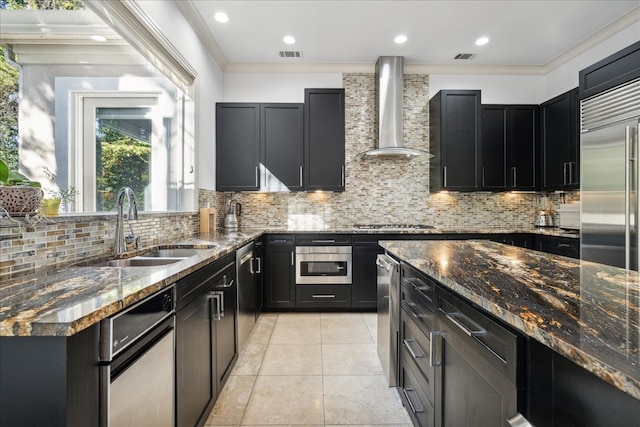 kitchen featuring ornamental molding, sink, wall chimney range hood, and dark stone countertops