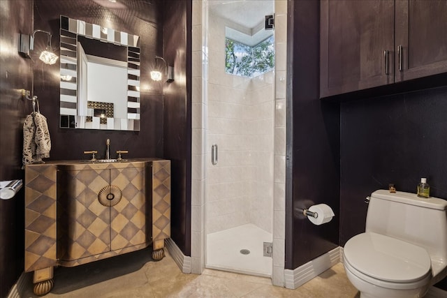 bathroom with a shower with door, vanity, toilet, and tile patterned flooring