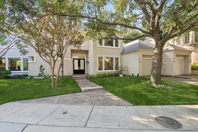 view of front of home with a front lawn and a garage