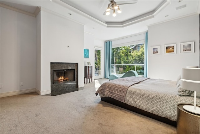 bedroom with light carpet, crown molding, a raised ceiling, and ceiling fan