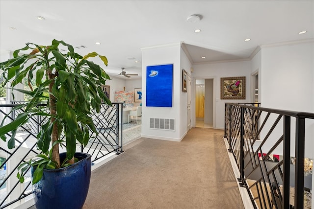 hall featuring crown molding and light colored carpet