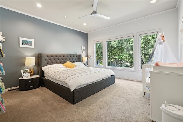 carpeted bedroom featuring ceiling fan and crown molding