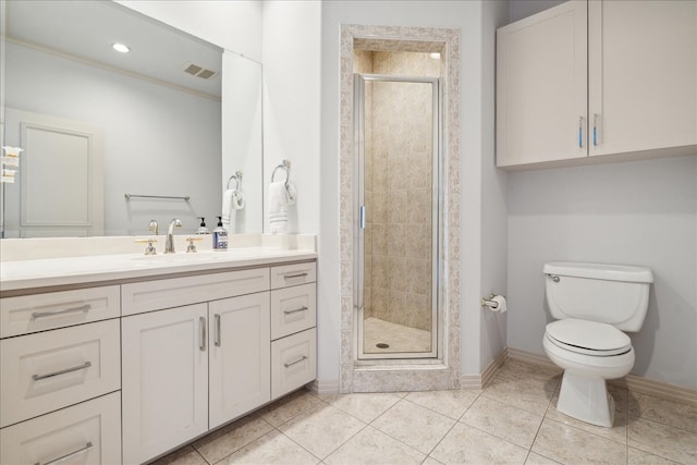 bathroom featuring vanity, toilet, a shower with shower door, and tile patterned flooring