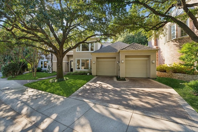 view of front of house with a garage and a front lawn