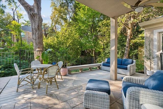 view of patio featuring outdoor lounge area, a wooden deck, and ceiling fan