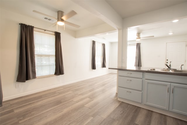 interior space with hardwood / wood-style floors, vanity, and ceiling fan