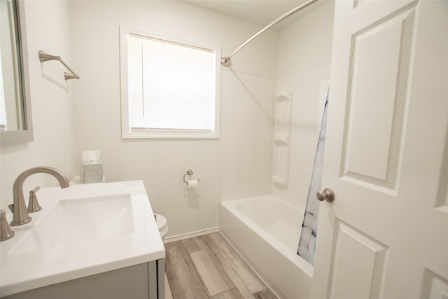 full bathroom with shower / washtub combination, hardwood / wood-style floors, vanity, and toilet